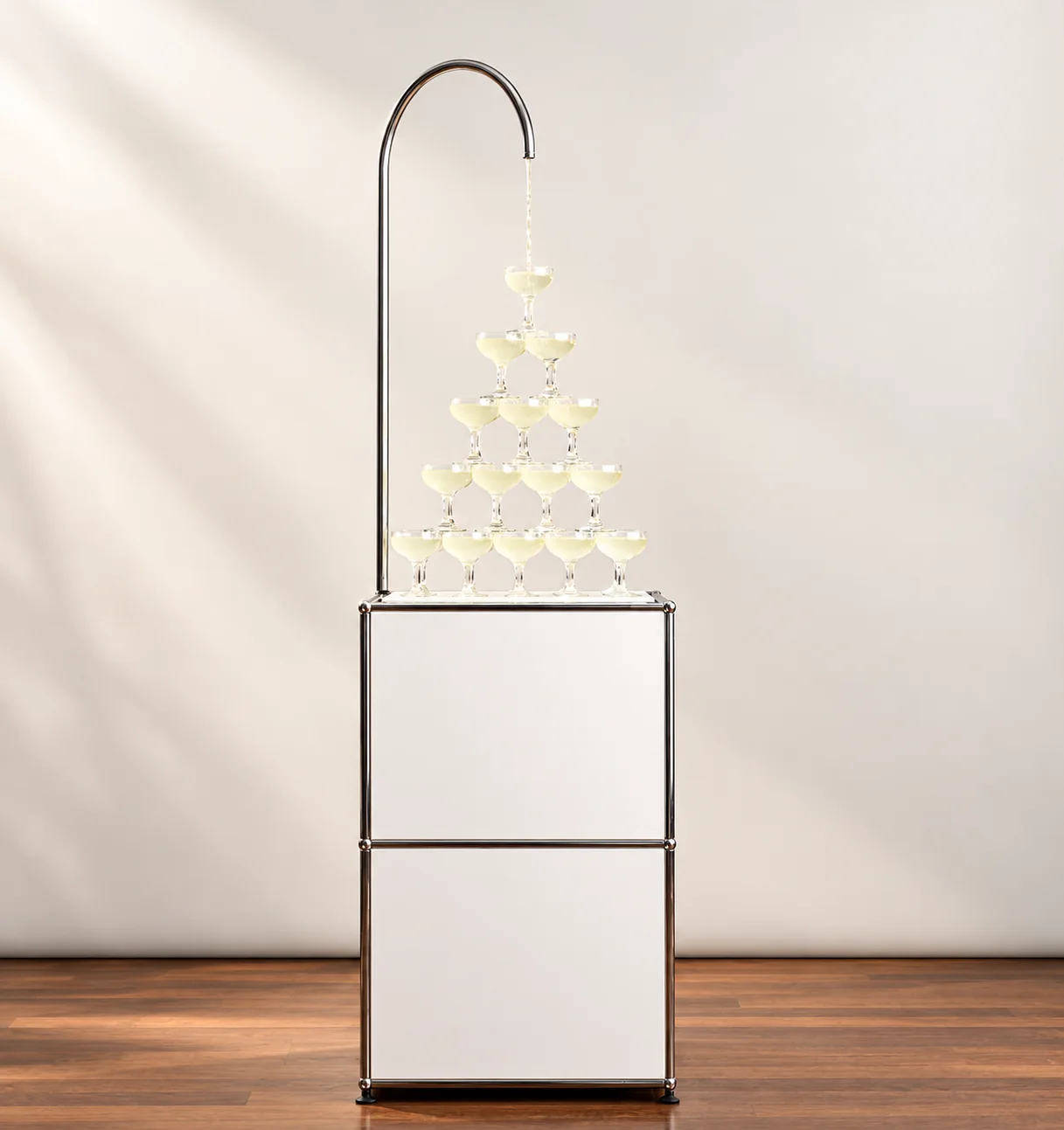 Cocktail fountain pouring a welcome drink into a tower of coupe glasses