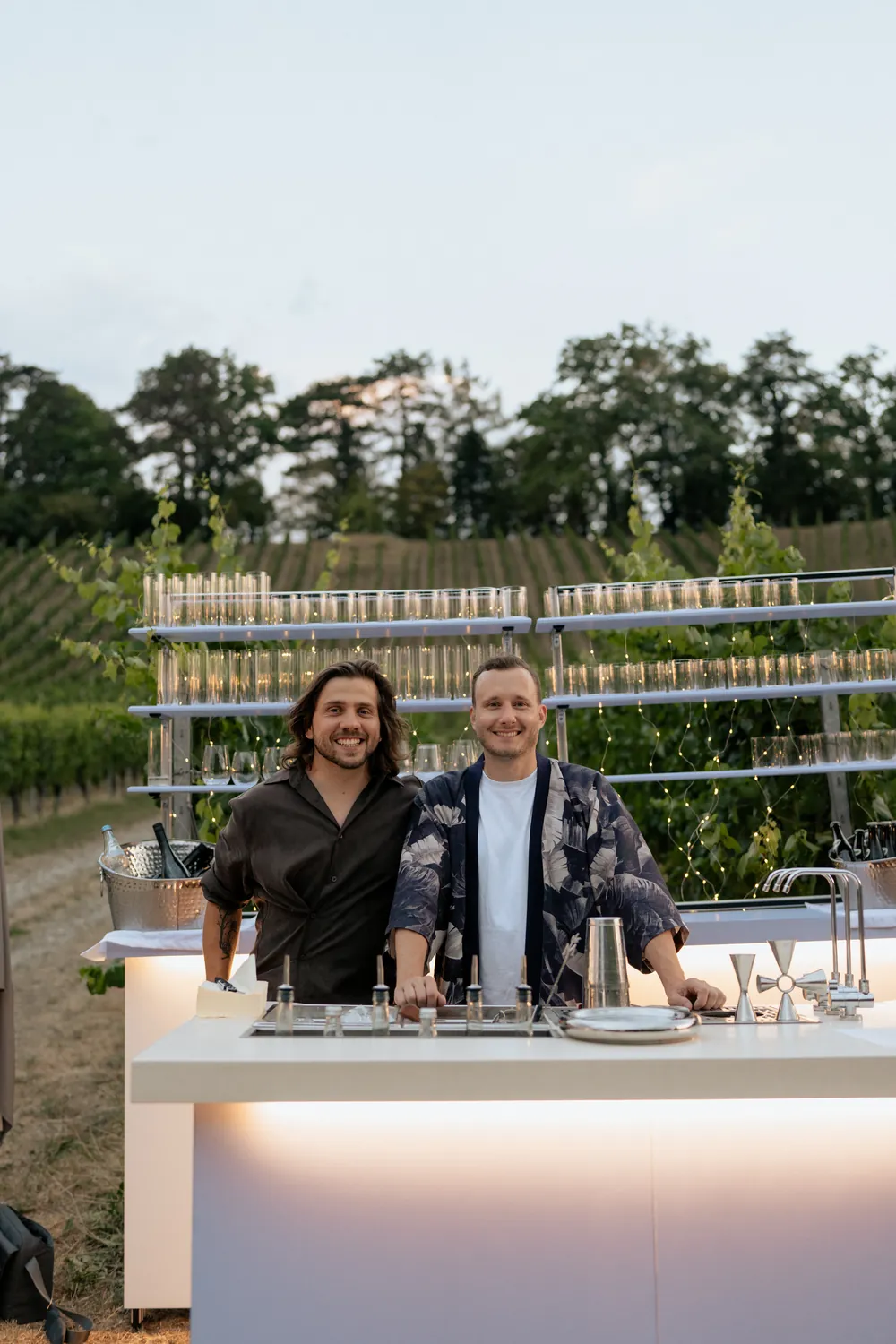 Maty and Jan behind their mobile bar in a vineyard